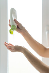 Putting shower gel on the hands.