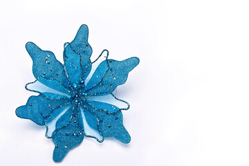 Fototapeta premium Cyan blue fabric and sequin poinsettia Christmas craft with space for text, minimal concept