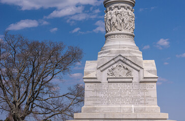 USA, Virginia, Yorktown - March 30, 2013: Yorktown Victory Monument, podium and pedestal tells story of siege, battle, and surrender, chiseled in gray stone with emblems of France and USA. - Powered by Adobe