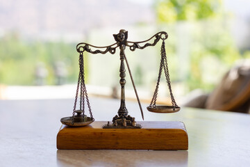 Imbalanced weighing scale miniature with weight on left plate. Weigh instrument, law, justice concepts