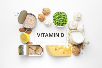 Text VITAMIN D and different healthy products on white background