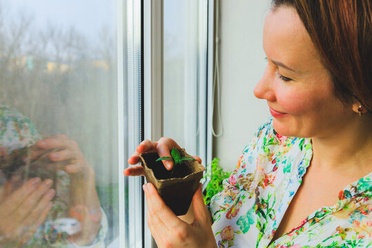 A girl photographs potted plants that she has grown in her home garden