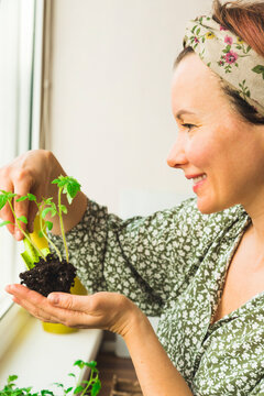 A girl photographs potted plants that she has grown in her home garden
