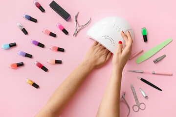 Woman doing manicure on pink background - obrazy, fototapety, plakaty