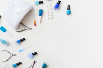 Set of tools for manicure and nail polishes on white background