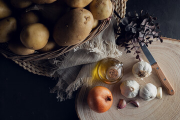 Potato basket on black background in overhead view