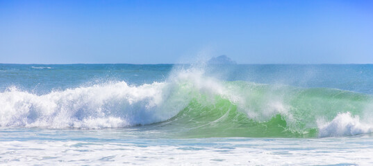 Beach landscape with wave and island.