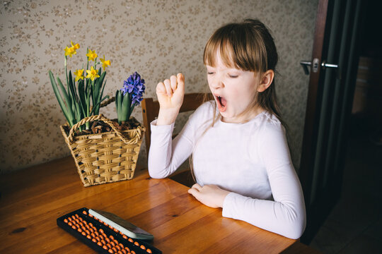girl learning to count on abacus