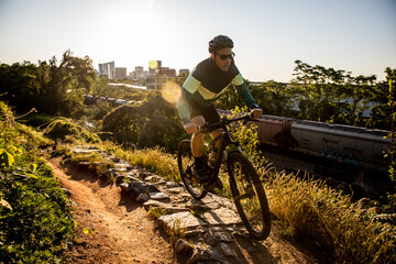 Mountain biker at sunrise with Richmond skyline in the background.