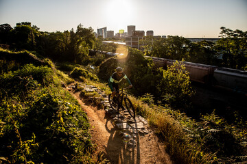 Mountain biker at sunrise with Richmond skyline in the background.
