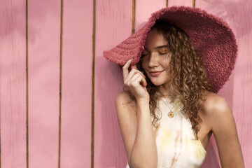 portrait of a beautiful fashion girl with curly hair in a yellow