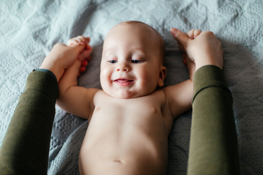 Smiling baby while morning physical exercises