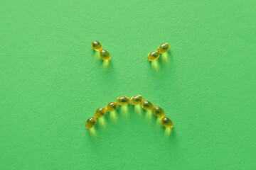 Face made of pills on color background