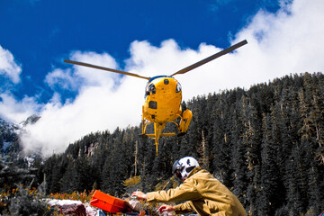 A helicopter prepares to land picking up workers at a remote location.