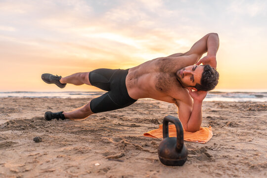 difficult isometric abdominal with muscular and hispanic man on the be