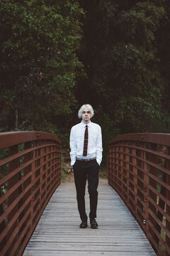 Portrait of Gen Z Teen on a Rust Colored Bridge Hands in Pockets