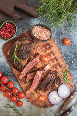 beef steak on a wooden board, chopped cuts of grilled meat