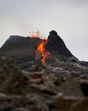 Active volcano exploding with igneous lava