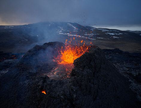 Burning lava splashing in rough volcano crater