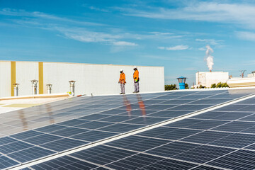 Unrecognizable solar panel technicians checking an installation Spain