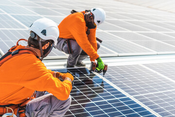 Unrecognizable solar panel technicians teamworking in Spanish factory