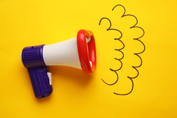 Toy megaphone on color background