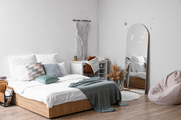 Interior of stylish bedroom with mirror