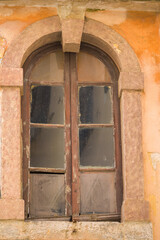 Fototapeta na wymiar A very old window in a quiet street