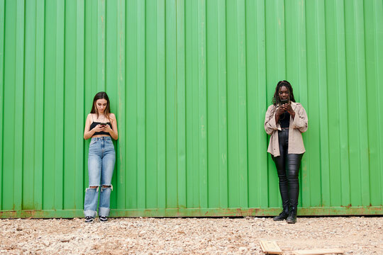 Two young multi-ethnic women keep a safe distance from each other