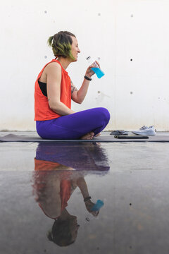 Athlete woman reflecting after a yoga session with isotonic drink