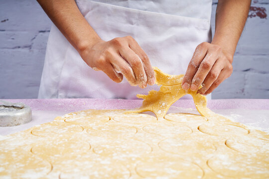 Removing the dough after cutting the cookies