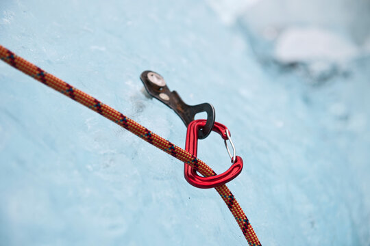 karabiner attached to ice screw on iceberg in the south of Iceland