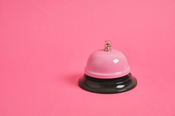 Ring alarm service pink metal bell on pink background. - obrazy, fototapety, plakaty