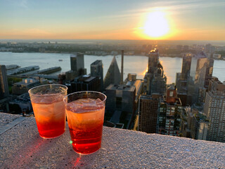 A couple of Spritzs on the rooftop of a skyscraper over the Hudson river