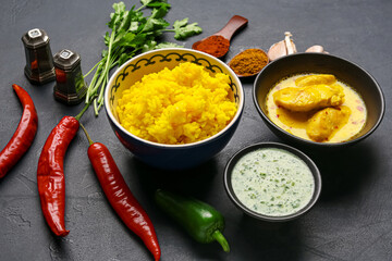 Traditional Indian food with spices on dark background