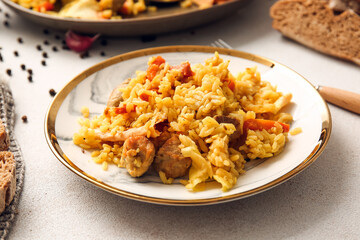 Plate with tasty Shah Pilaf on light background