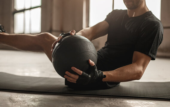 Man doing abs exercise with medicine ball