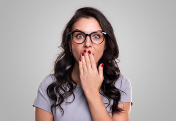 Surprised woman covering mouth with hand