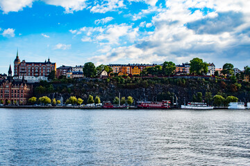 Beautiful, Colorful, Traditional Buildings Sit on the Rocky Cliffs of the Katarina-Sofia Island with Boats below in Stockholm, Sweden