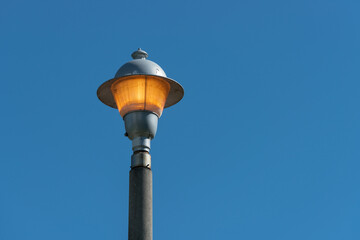 Fototapeta na wymiar old street lamp on blue sky