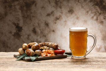 Mug of fresh beer and snacks on table. Oktoberfest celebration