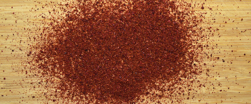 Organic aromatic sumac texture on bamboo cutting board