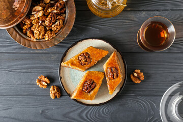 Composition with tasty baklava on dark wooden background