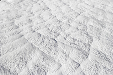 Background abstract texture of gray-white calcium deposit on surface stone. Pamukkale travertine surface in Turkey