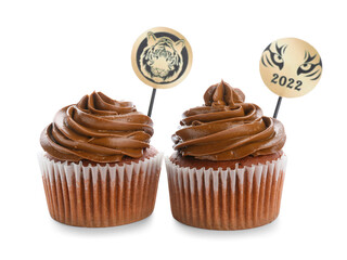 Tasty cupcakes for New Year 2022 celebration on white background