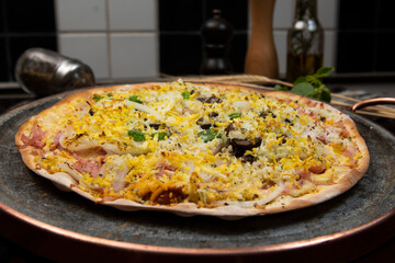 Brazilian Portuguese-style pizza with ham, egg, pepper, onion, mozzarella