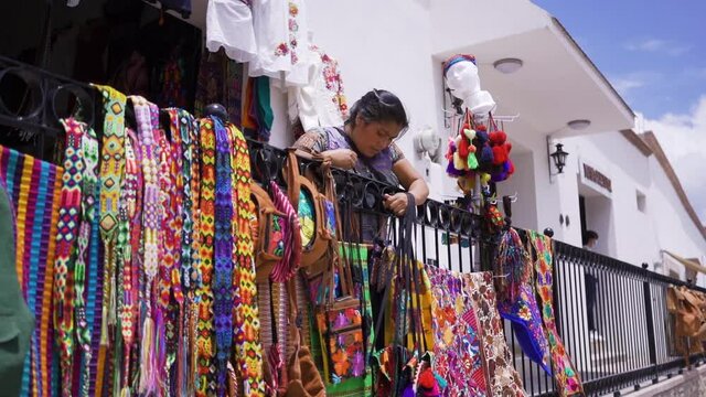 Indigenous woman selling regional Mexican clothing in store. Regional clothing from Chiapas, Mexico