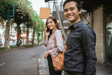 Fototapeta premium Business man and woman walking trough sidewalk smiling going to office
