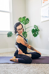 Woman doing yoga twist at home