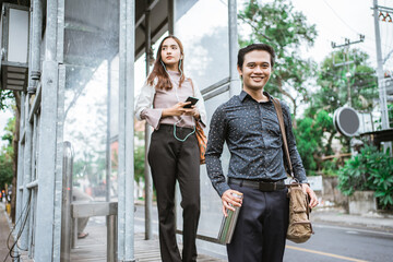 Business man and woman walking trough sidewalk smiling going to office